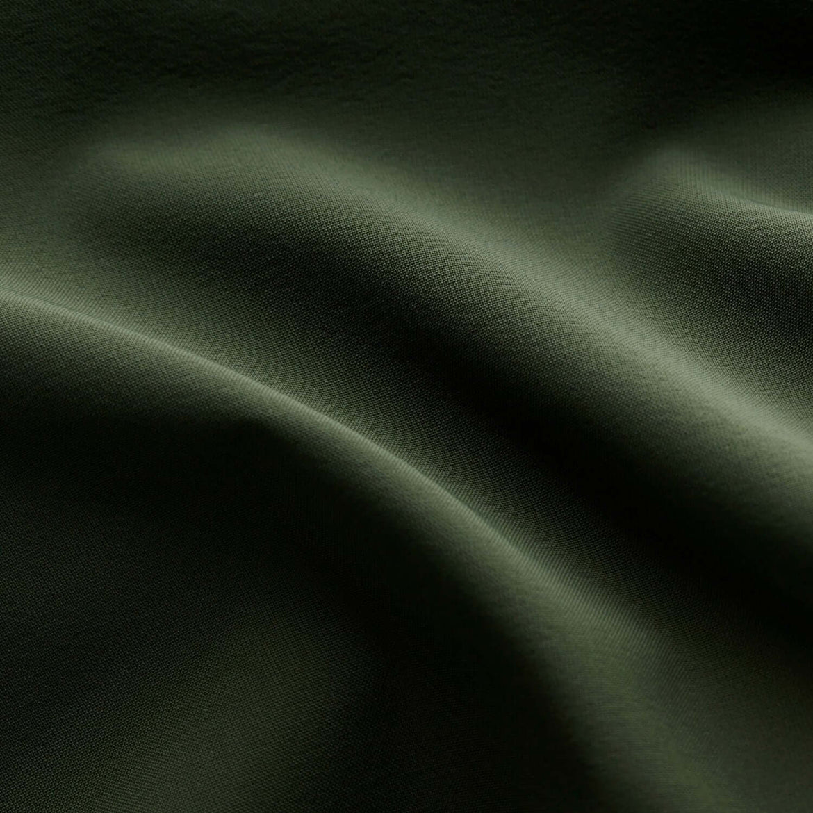 Dark green fabric texture with folds