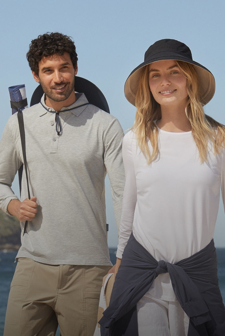 Man and woman standing outdoors with a clear blue sky background